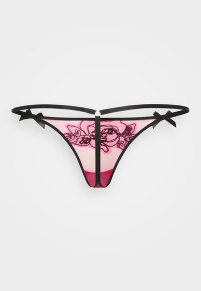 Lillekest lakk, millel on must lilleline muster roosa läbipaistva tausta peal, mustad rihmad ja lipsud ning tahke roosa paneel taga.