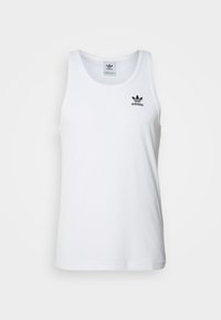 Top de tirantes blanco con textura acanalada, cuello redondo y logo de Adidas en negro en el pecho. Tejido suave con diseño ajustado y dobladillo recto.