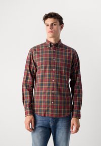 Geruite shirt in rood, groen en geel. Met knoopkraag, lange mouwen met knoopmanchetten en een borstzak. Katoenen stof, casual pasvorm.