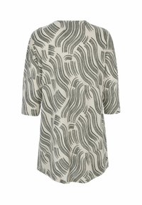 Beige long-sleeve tunic with abstract black wavy line patterns, crew neckline, and loose fit.