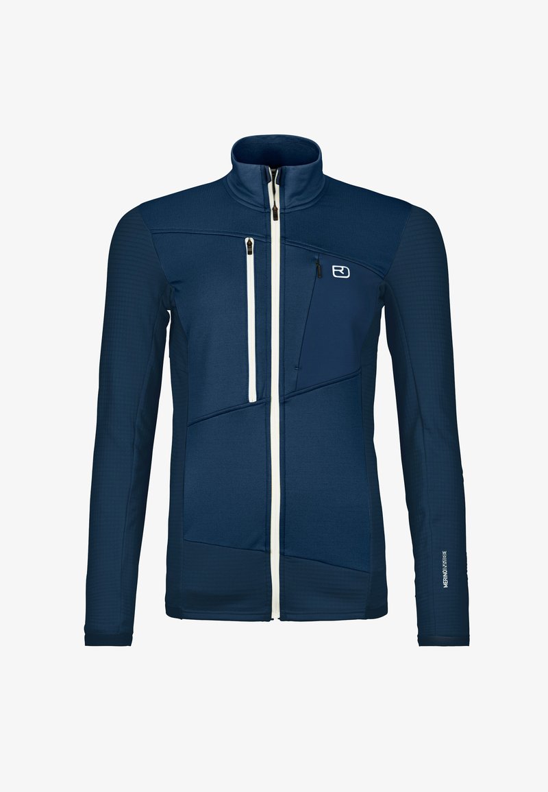 Navy blue athletic jacket with a stand collar, textured panels, white zippers, and logo. Features multiple zippered pockets and fitted design.