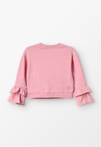 Rosa, kort sweatshirt i mjukt tyg med utställda volanger i ärmsluten och en liten broderad hjärtdetalj.