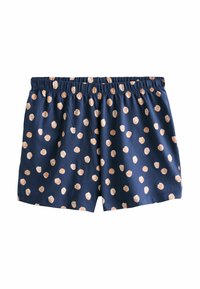 Pantalones cortos azul marino con cintura elástica y lunares irregulares beige distribuidos uniformemente por toda la tela.