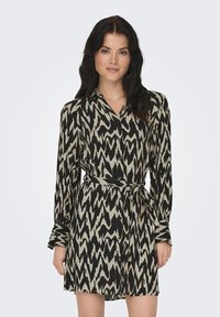 Μαύρο και μπεζ φορεμα με σχέδιο, με γιακά, μακριά μανίκια και κορδόνι στη μέση. Ελαφρύ υλικό με αφηρημένο σχέδιο ζιγκ-ζαγκ.