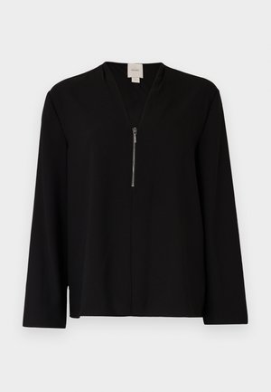 Top nero a maniche lunghe con scollatura a V, dotato di una cerniera anteriore e una texture liscia. Silhouette semplice e ben strutturata.
