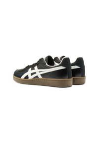Black and white sneakers with a textured leather upper, featuring a beige rubber sole and distinctive white stripe design on the sides.