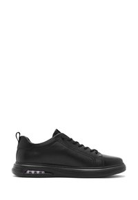 Sneaker in pelle nera con superficie liscia, punta arrotondata e design con lacci. Presenta un cuscinetto d'aria visibile nella suola.