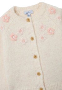 Cardigan crème avec des fleurs roses brodées, col rond et boutons en bois. Tissu en maille texturé avec une finition douce. Taille 12-18 mois.