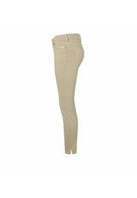 Jeans skinny beige hechos de algodón elástico. Presentan una cintura de altura media, lazos para cinturón, cinco bolsillos y una textura ligeramente deslavada.