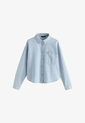 Gaiši zila pogājama krekls no teksturētas auduma. Ir apkakle, garas piedurknes un krūšu kabata. Īss apakšmala dizains.