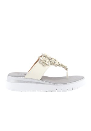 Sandalo con zeppa bianco con cinturino a infradito decorato con applicazioni floreali bianche e argentate e sottopiede imbottito.