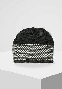 Black knit beanie with a textured top and a white open weave band. Features a rounded shape and is made of soft, flexible material.