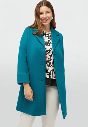 Abrigo de mezcla de lana en color verde azulado con cuello con muescas, mangas largas y bolsillos laterales. Presenta un corte relajado y botones en la parte delantera.