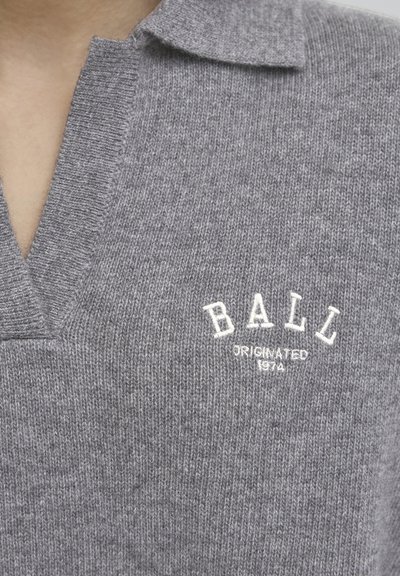 Gray wool polo shirt with a V-neck, textured knit, and a white embroidered logo reading "BALL" with "ORIGINATED 1974" below.