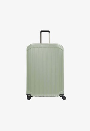 Valigia rigida verde chiaro con design a coste testurizzate, manico retrattile nero e quattro ruote per la mobilità.