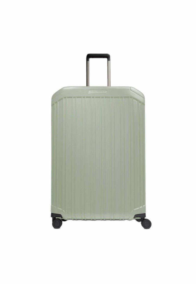 Valise rigide de couleur vert clair avec un design rainuré texturé, poignée rétractable noire et quatre roues pour la mobilité.