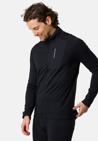 Black zip-up jacket with a high collar, slim fit, and a textured panel on the upper left chest featuring a logo. Smooth, elastic fabric.