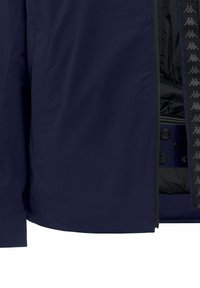 Navy blue jacket partially open, showing black lining with repeated light gray logo pattern and snap button details inside.