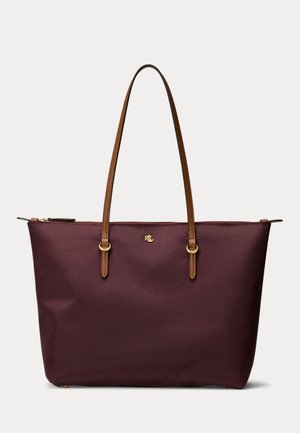 Sac cabas violet foncé avec longues poignées en cuir marron, fermeture éclair dorée et petit logo RXL doré au centre devant.