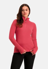 Langemouwen, kwart-rits pullover van levendig roze stof. Bevat duimopeningen in de manchetten en subtiele stikdetails voor extra textuur.