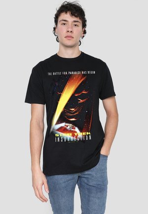 Black cotton t-shirt featuring a colorful "Star Trek: Insurrection" graphic, with text and space-themed imagery. Casual fit, short sleeves.