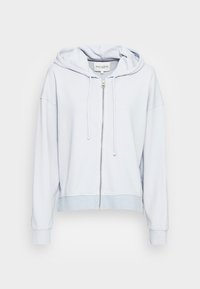 Sudadera con capucha de cremallera de color azul claro, hecha de un tejido suave, que presenta un corte relajado, capucha ajustable y puños y dobladillo de canalé.