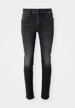 Dark grey, high-waisted skinny jeans with a faded look. Features five pockets, belt loops, and a classic button closure.