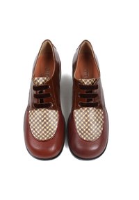 Brązowe skórzane buty z błyszczącą cholewką, z panelem palców w wzór houndstooth oraz podwójnym zapięciem na sznurowadła, płaska czarna gumowa podeszwa.