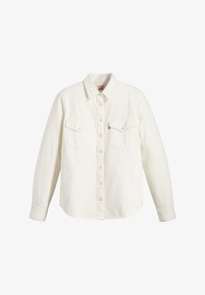 Camicia bianca a maniche lunghe realizzata in cotone. Presenta una chiusura frontale con bottoni, due tasche sul petto e un colletto classico con bottoni argentati.