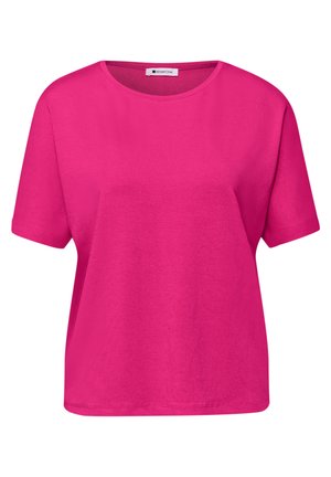T-shirt court en coton rose vif à manches courtes avec col ras-du-cou et ourlet droit, arborant une petite étiquette blanche au niveau du col.