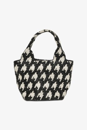 Helmehelbe riidest kott, millel on musta ja valge houndstooth mustriga disain, ümar ülaosa ning kahekordsed kätised. Tekstuuriga pind ja struktureeritud kuju.