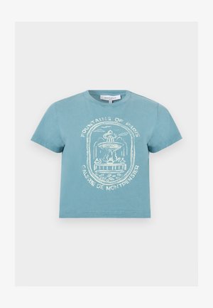 Light blue short-sleeve t-shirt with white sketch of Paris fountain and text “Fountains of Paris Galerie de Montpensier” on front.