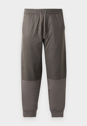 Dunkelgraue Sporthose mit elastischem Bund und verstellbarem Kordelzug. Verfügt über glattes Material mit gerippten Bündchen und kontrastierenden Einsätzen.