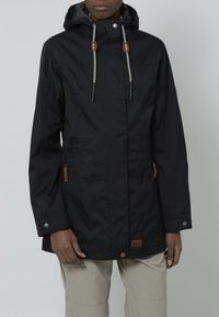 Black waterproof jacket with a hood, drawstring accents, side pockets, and brown leather detailing at the hem and zippers. Smooth texture.