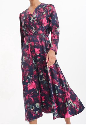 Blommig omlottklänning i marinblått, med en blandning av rosa och gröna mönster, långa ärmar och en flödande A-linjeformad kjol. Slätt, lätt tyg.