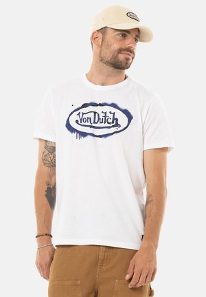 White cotton t-shirt featuring a blue Von Dutch logo with a dripping design. Short sleeves and round neckline, with visible tattoo detail on arm.