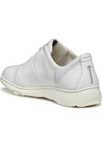 White leather slip-on shoe with a textured upper, rounded toe, and a cushioned sole; features a subtle logo and striped inner lining.