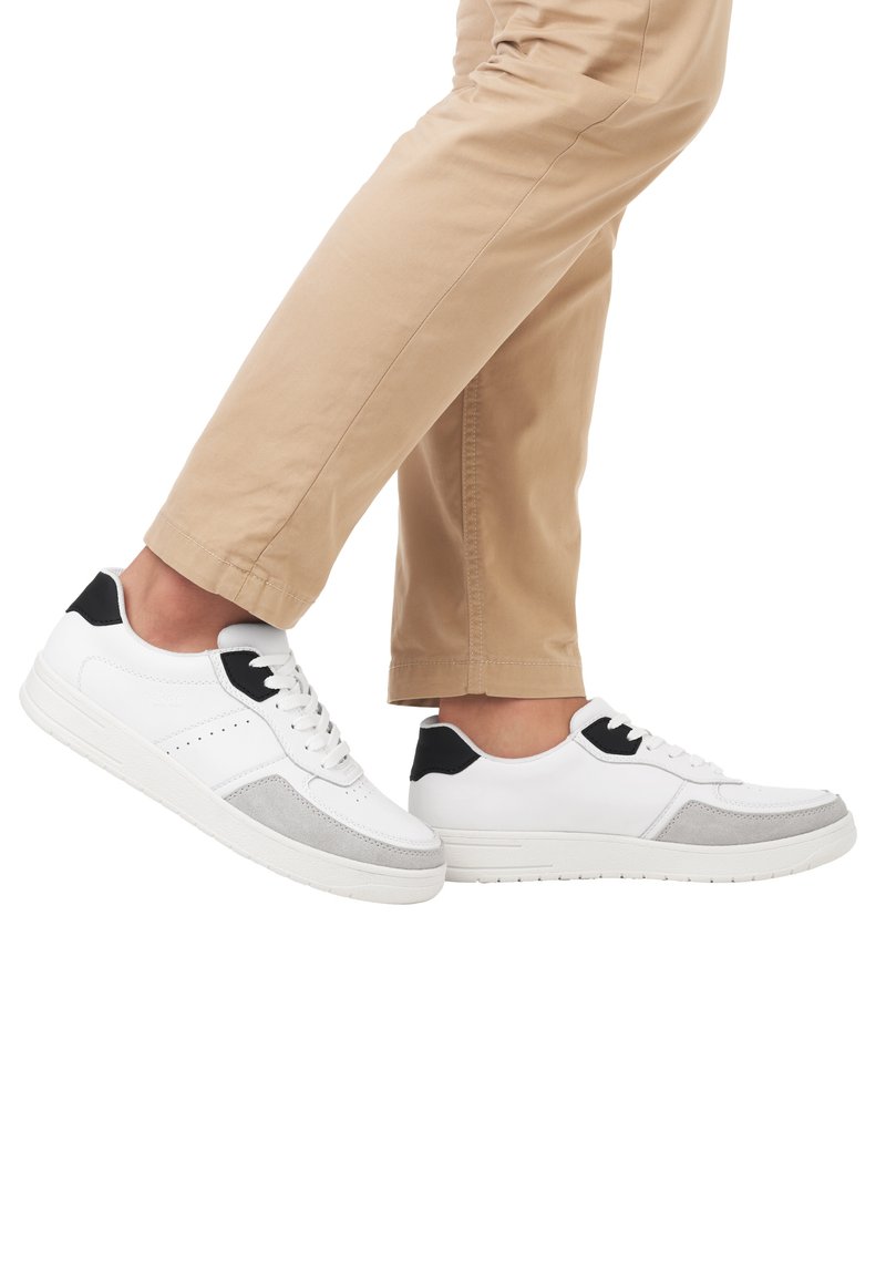 White sneakers with gray suede accents and a black heel tab. Features a round toe, perforated detail, and textured sole.