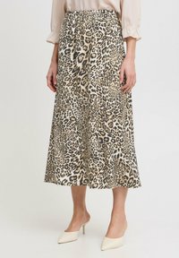 Leopard print midi skirt with an elastic waistband, made of lightweight fabric; features a flowing A-line shape and soft texture.