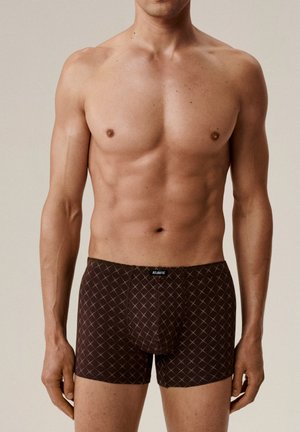 Brązowe bokserki o kroju przylegającym z wzorem w romby, wykonane z gładkiej tkaniny i z logowaną gumą w pasie. Dopasowany krój i długość do połowy uda.