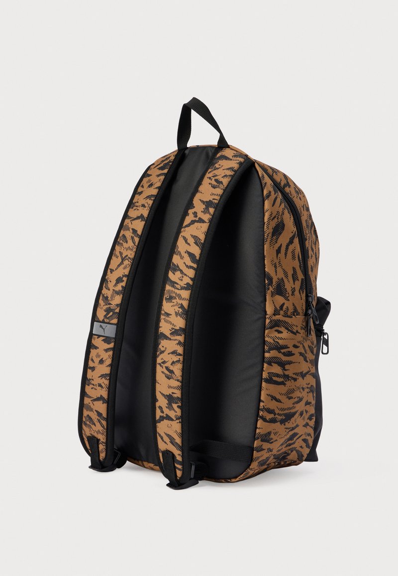 Sac à dos imprimé tigre marron et noir avec une coque extérieure durable, des bretelles rembourrées et des zips doubles. Compartiment principal spacieux.