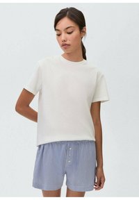 White short-sleeve T-shirt with a round neckline, paired with blue and white striped shorts featuring a drawstring and three buttons.