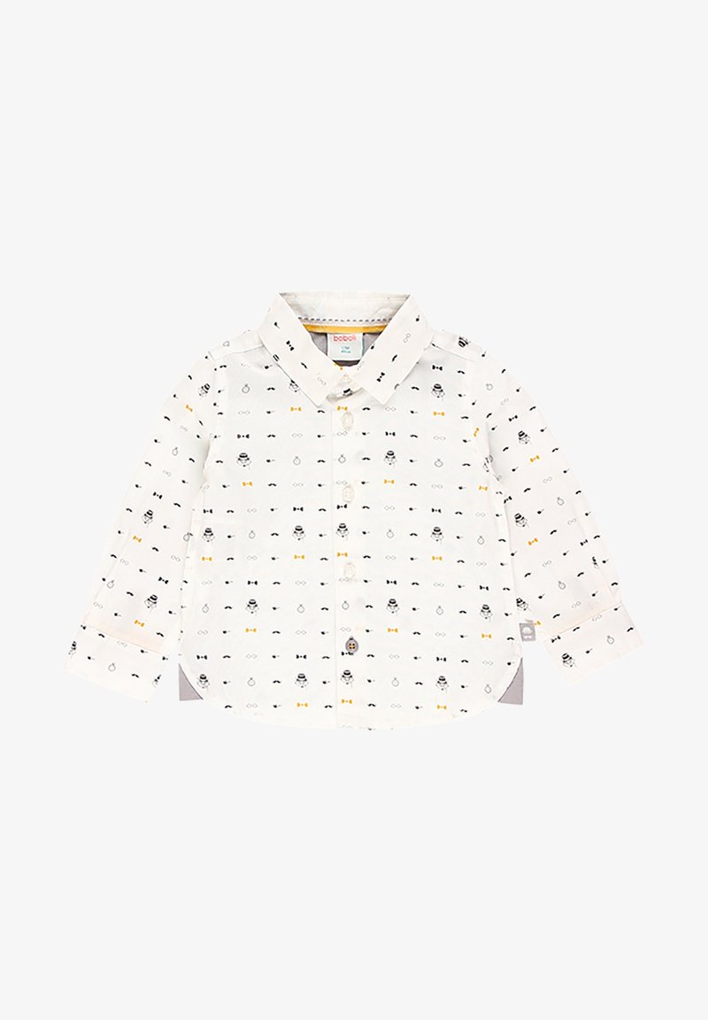 Chemise à boutons en tissu blanc avec un motif de nœuds papillon noirs et jaunes et de visages. Manches longues, ourlet arrondi et col.