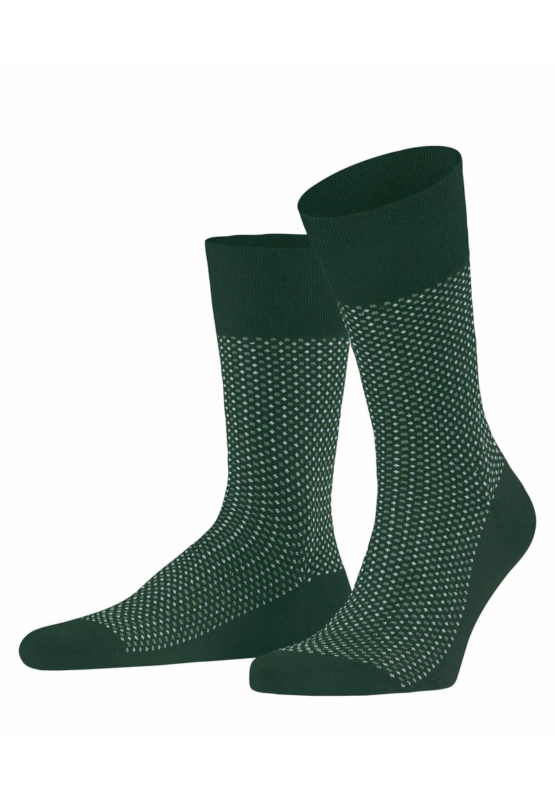Grüne Socken mit einem kontrastierenden strukturierten Design, das kleine weiße Punkte aufweist. Hergestellt aus einem weichen, dehnbaren Stoff mit einem gerippten Oberrand.