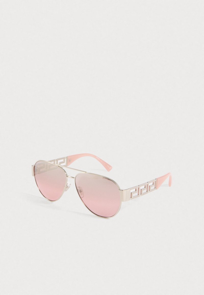 Ochelari de soare cu lentile aviator roz-tintate, cadru din metal auriu și brațe cu model roz pe un fundal alb.
