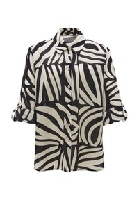 Blouse à motif noir et blanc avec col, devant boutonné et manches retroussées. Fabriquée en tissu léger et semi-transparent.