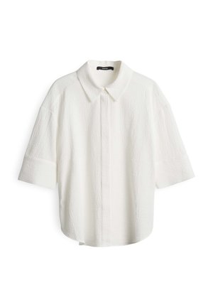 Weißes Kurzarmhemd mit kragenformendem Ausschnitt. Strukturierter Stoff mit einem dezenten Knitterdesign und einer lockeren Passform. Vorderer Knopfverschluss.
