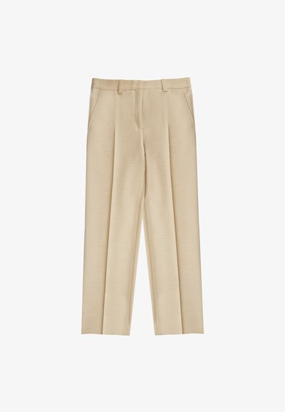 Pantalons beige ajustés en tissu texturé avec des plis à l'avant, des passants de ceinture et deux poches latérales. Design épuré avec jambes droites.