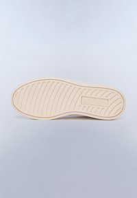 Shoe outsole in cream with textured grooves and a logo. Smooth rubber material designed for grip and durability.