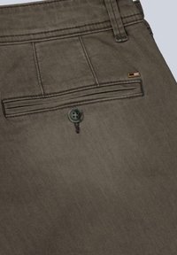 Olive green fabric pants with a back pocket featuring two horizontal seams and a black button; includes a small logo tag near the waistband.
